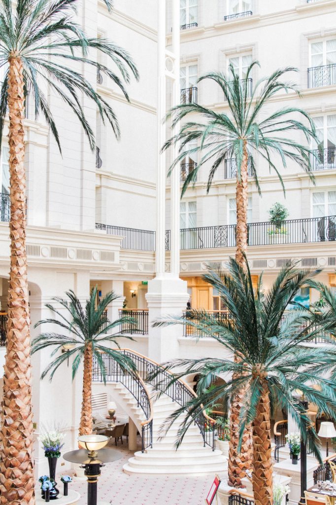 Palm trees and the main staircase at the Landmark Hotel in London