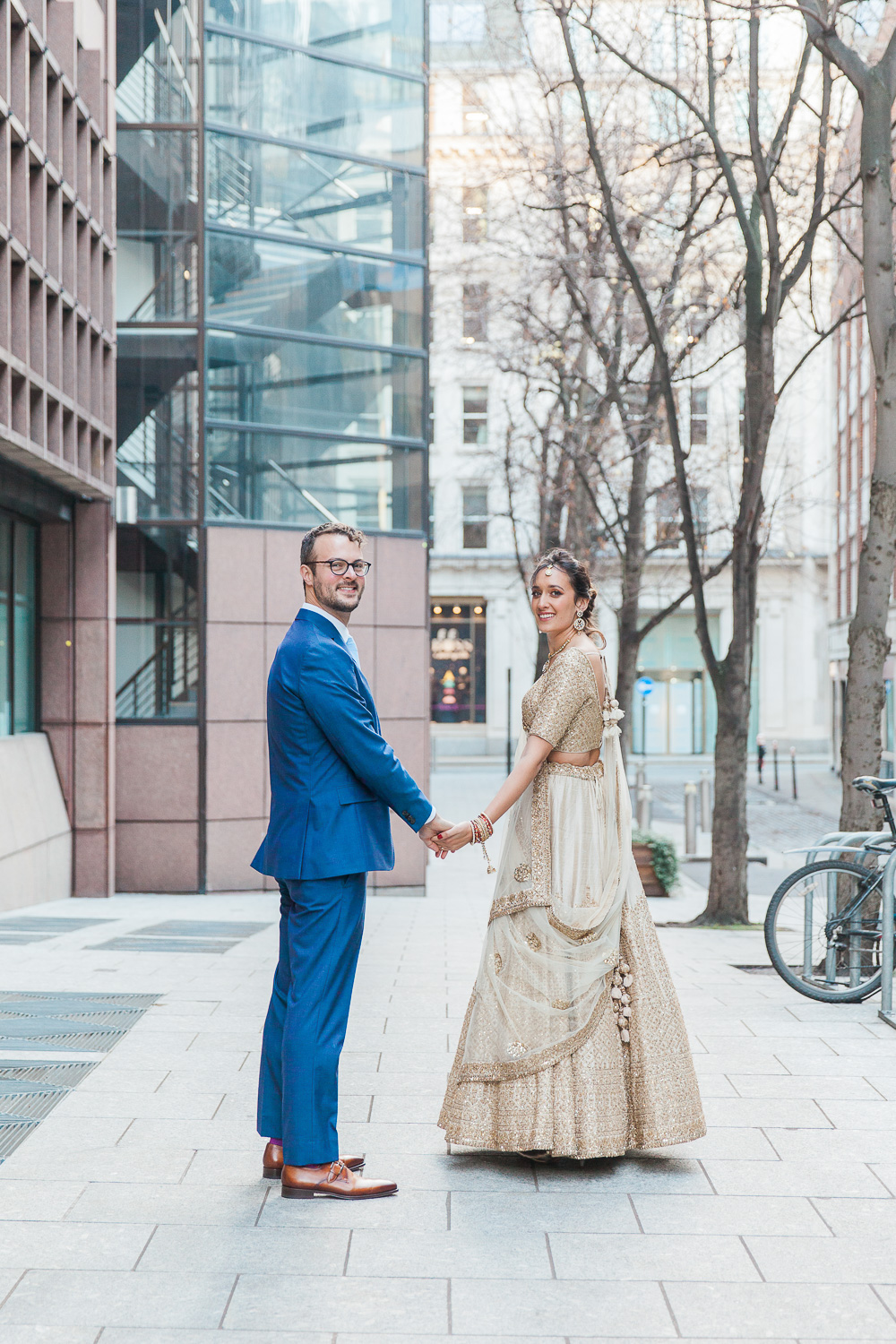 Bride and groom on the streets of London during their multicultural wedding