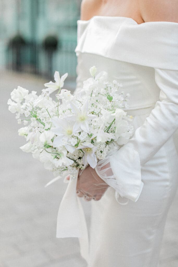 A close up of the brides white bridal bouquet.