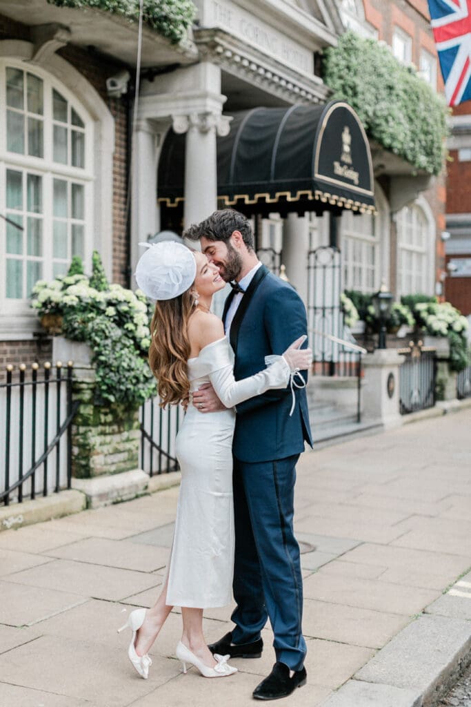 Bride and Groom embracing outside The Goring Hotel in Belgravia, London.