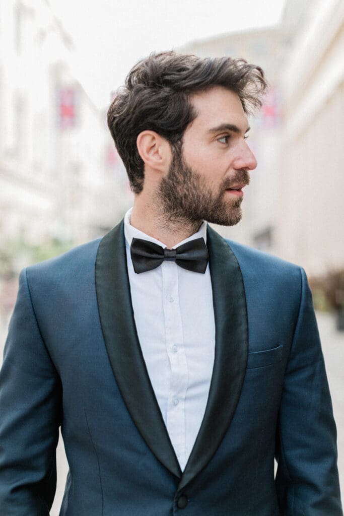 Close up of the groom in his grooms suit and bow tie.