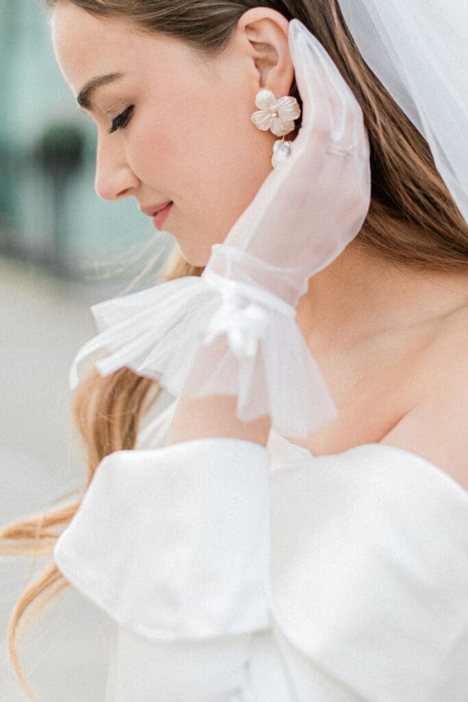 Close up of the bride wearing her earrings
