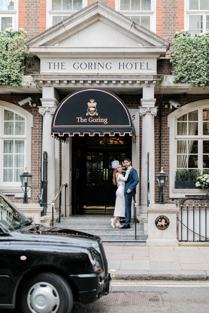 Bride and Groom standing outside The Goring Hotel in Belgravia, London, after the legal wedding ceremony.