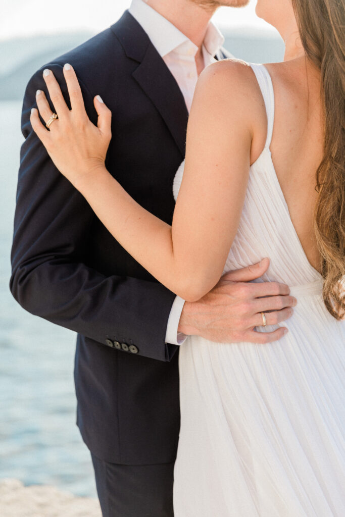 Close up of the bride and groom embracing at their wedding in Greece.