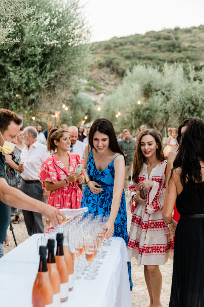 Guests being served champagne at wedding reception in Ithaca, Greece.