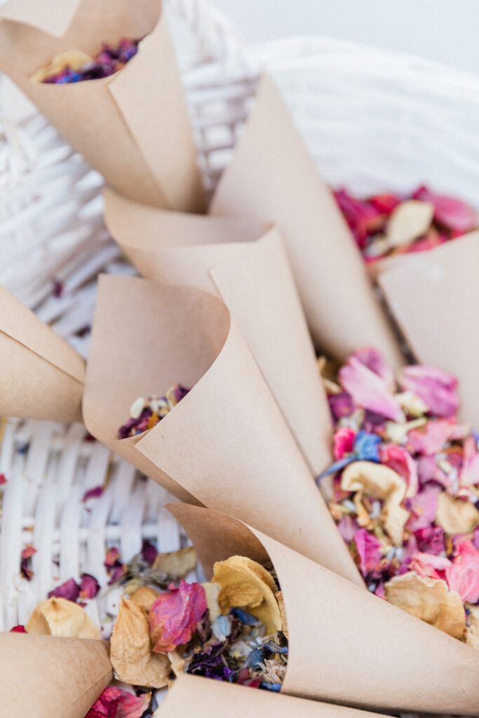A close up of confetti in paper cones for wedding ceremony.