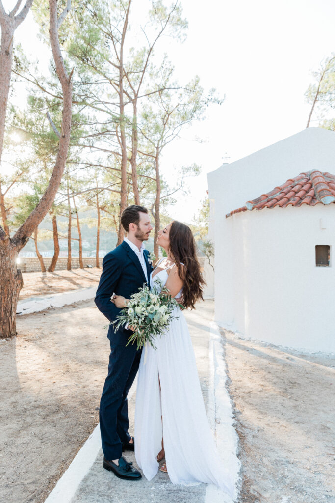The bride and groom looking into each others eyes whilst standing outside the church they've just got married in.
