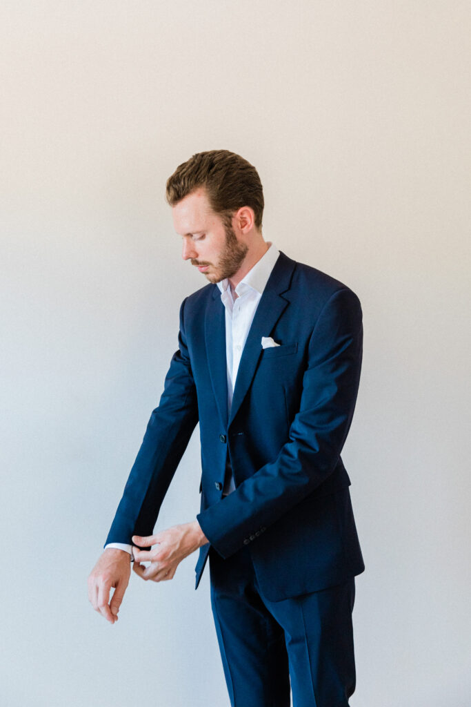 Groom getting ready and dressed into his wedding attire for his wedding in Greece.